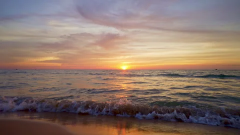 Seashore at Sunset. Small Waves Roll on the Shore. Golden Time. The Rays of the Stock Footage 255929514