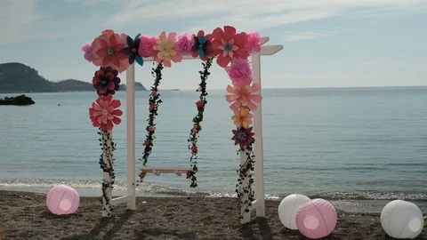 On the seashore swing empty swings decorated with flowers and balls Stock Footage 74692199