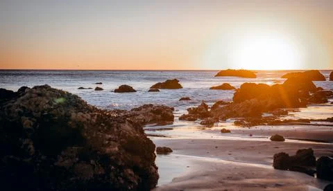 Seashore under a sunset Stock Photos