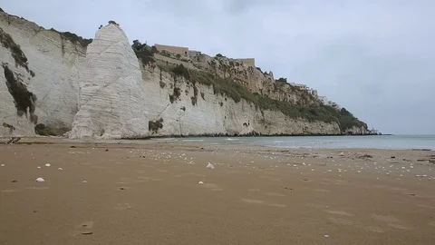 Seashore in Vieste, Italy. White cliffs and sandy beach on cloudy day Stock Footage 109132936