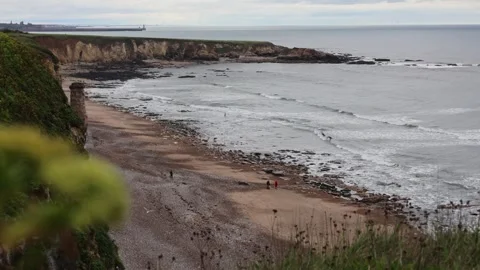 Seashore View With Few People on a Beach on a Cloudy Day Stock Footage 246939990