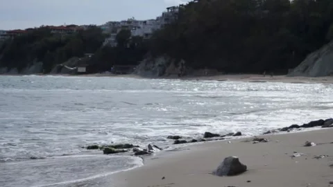 Seashore. View of the waves being lapped by the wind on the sandy shore. Rocky Stock Footage 315179761