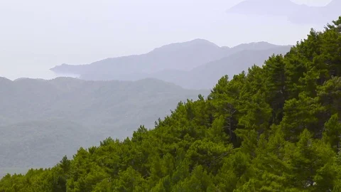 A seaside and a mountain peaks in a light fog Stock Footage 74942944