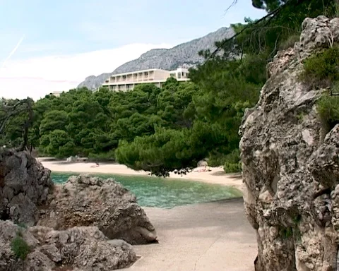 Seaside of Brela lagoon thru large porous marine textured stones. Stock Footage 105282550