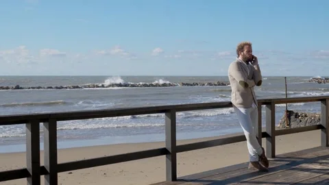 Seaside Call: Man's Pensive Conversation Stock Footage 265593487