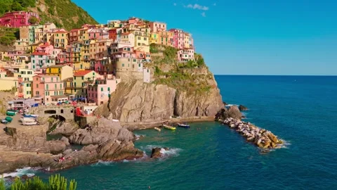 Seaside cliff view of Manarola with dramatic skies and tranquil sea. Stock Footage 311624411