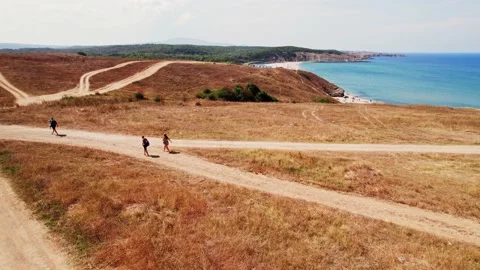 Seaside Cliffs Beach Fly Over Dunes to Reveal Parked Cars Black Sea Tourists Stock Footage 235665516
