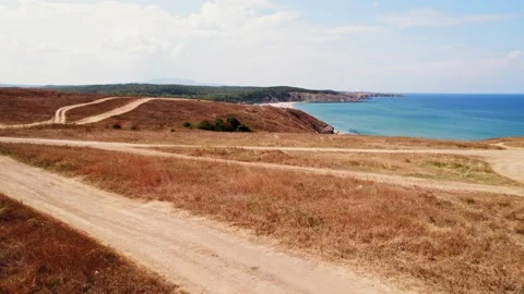 Seaside Cliffs Beach FPV Fly Through Dunes Parked Cars to Reveal Black Sea Shore Stock-Footage 235664895