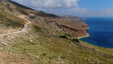 Seaside cliffs near Balos Beach on Crete Greece with two cars on the left Stock Footage 125869878