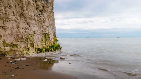 Seaside cliffs, people sailing in the background Stock Footage 74639101