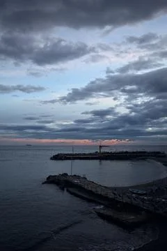 Seaside on a cloudy nightfall Stock Photos