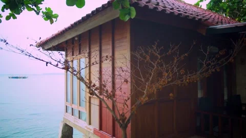Seaside cottage room with view of calm waves Stock Footage 332380547