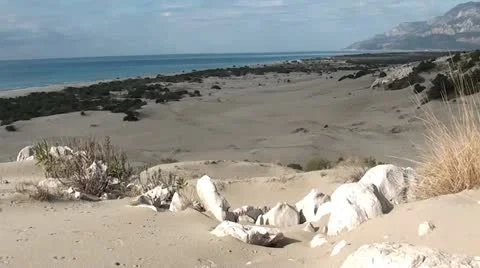 Seaside dunes and mountains panning Stock Footage 20537959