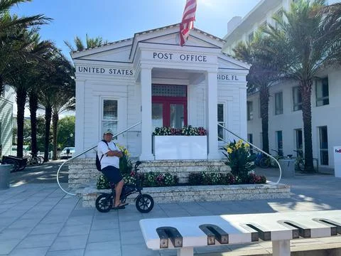 The Seaside, FL Post Office in the square in downtown with bicycles and peopl Stock Photos