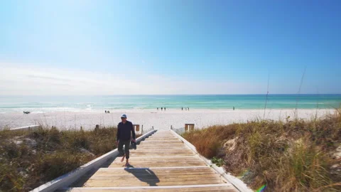 Seaside, Florida sunny winter day walking down boardwalk to beach paradise Stock Footage 160164341