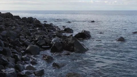 Seaside footage capturing the interaction between powerful waves and stationary Stock Footage 346890299