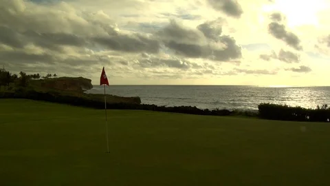 Seaside golf course putting green overlooks ocean tides Stock Footage 125336601