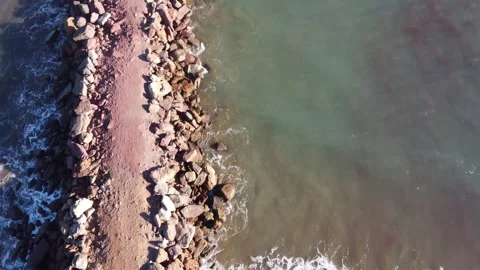 Seaside Groynes divider patch on the beach, sea separation, aerial top down Stock Footage 281013822