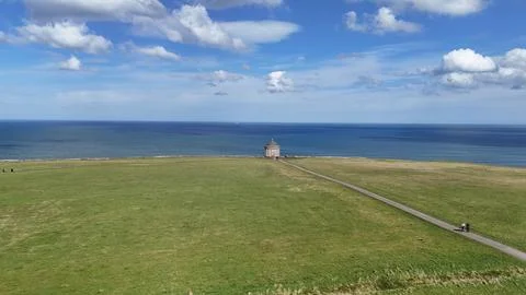 Seaside Meadow with  Distant Building Stock Photos