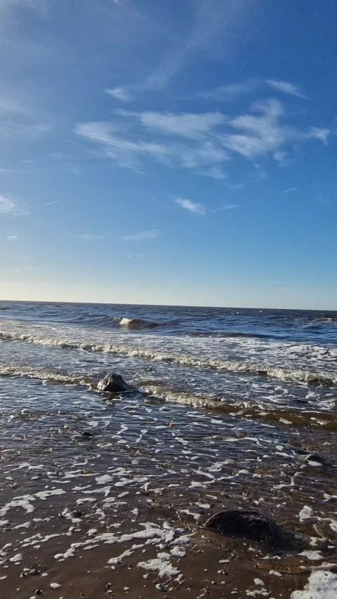 Seaside Pebbles and Foamy Waves at Sunset Stock Footage 299719487