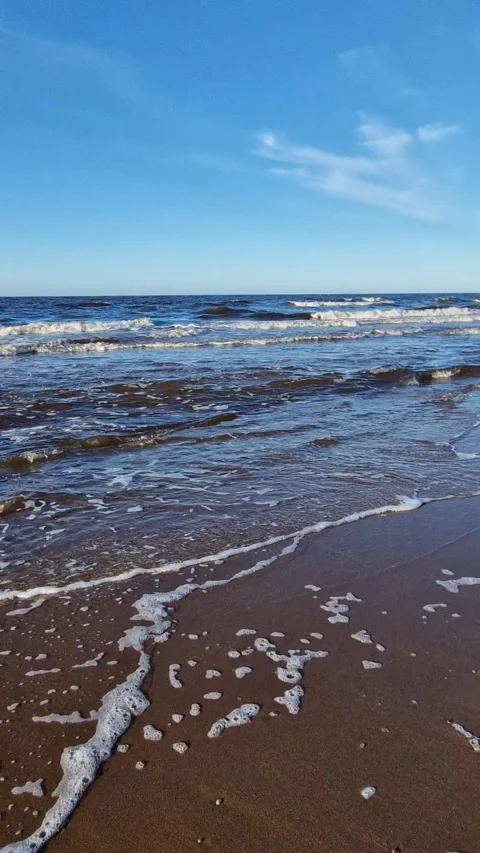 Seaside Pebbles and Foamy Waves at Sunset Stock Footage 299719538