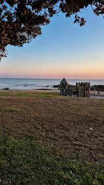 A seaside playground stands empty at sunset Stock Photos
