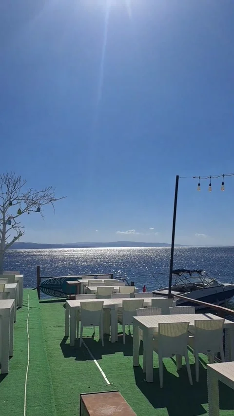 Seaside restaurant with white tables and chairs in Balikesir Stock Footage 346296468