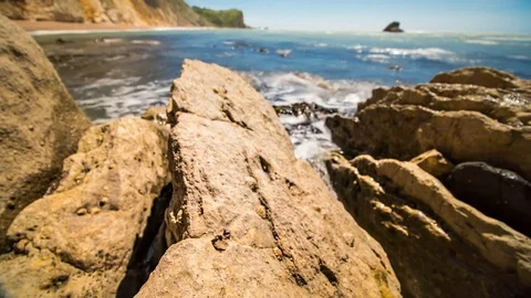 Seaside rocks beaten by waves timelapse Stock Footage 76587321