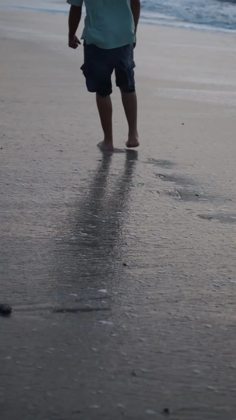 Seaside Stroll: Man Walking on the Beach Video stock 258294001