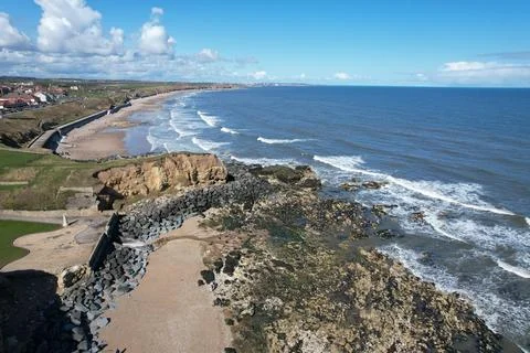 Seaside view of two beaches separated by a rocky formation. Stock Photos
