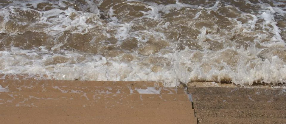 Seaside Waves Lapping on Steps Stock Photos