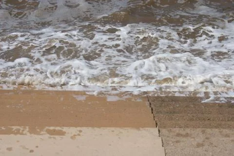 Seaside Waves Lapping on Steps Foto stock