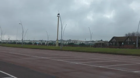 Seaside in winter, empty car park with caravan park in distance. Stock Footage 1092304