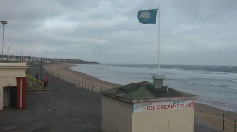 Seaside in winter on a very windy day, lifeguard flag flying Stock Footage 1097641