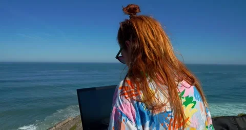 Seaside Workspace: A creative individual is immersed in her work Stock Footage 333232108