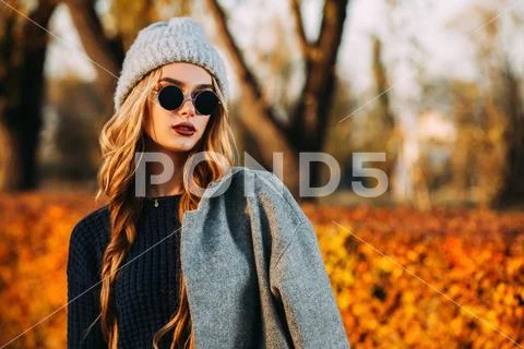 Seasonal autumn fashion. Modern young woman wearing fashionable warm clothes Stock Photos