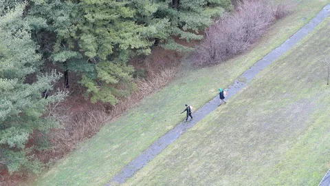 Seasonal Grounds Crew Using Leaf Blower Aerial Footage Stock-Footage 127260506