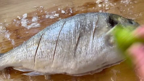Seasoning Fish with Lime Stock Footage 345305242