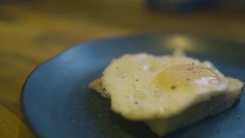 Seasoning a fried egg Stock Footage 286753774