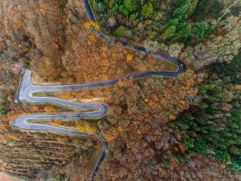 Seasons Concept winter or fall Aerial view Winding road serpentine mountain p Stock Photos