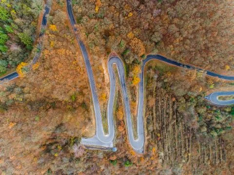 Seasons Concept winter or fall Aerial view Winding road serpentine mountain p Stock Photos