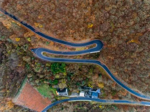 Seasons Concept winter or fall Aerial view Winding road serpentine mountain p Stock Photos