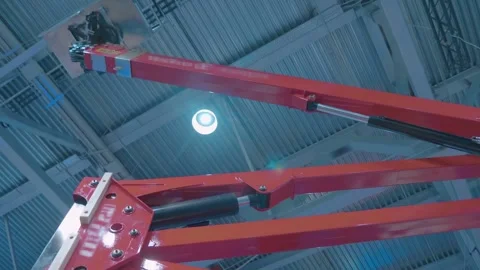 A seat and multiple control levers for lifting the basket on a red boom  Stock Footage 333382300
