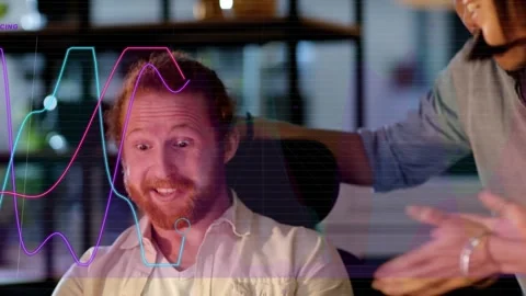 Seated bearded man showing positive tech results, causing graph lines and Stock Footage 333899089
