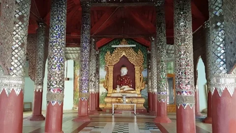 Seated Buddha statue in hall, decorated shiny columns, Shwezigon Pagoda, Bagan Vídeos de archivo 78336752