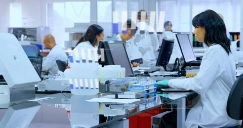Seated clinical tech handling samples using monitor as camera panning, overlays Stock Footage 331701181