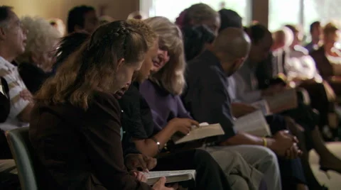 Seated congregation reading their Bibles Stock Footage 59536988