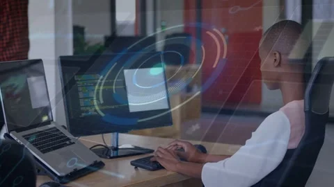Seated developer reviewing code using mouse, keys while HUD overlay appearing, Stock Footage 332591718