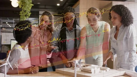 Seated lead starting data graphs, 5 women leaning over model with wind turbines Stock Footage 333233191