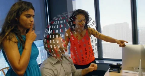 Seated man gesturing with colleagues in tech office activating rotating binary Stock Footage 317206344